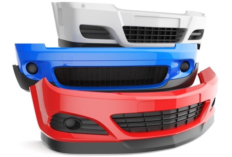 Three car bumpers in white, blue, and red are stacked on top of each other against a plain white background.